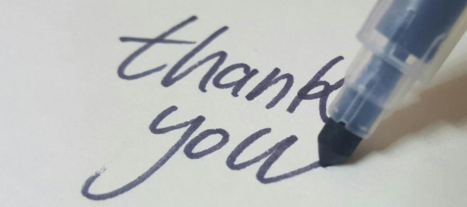 handwritten thank you note with a black marker pen: the words read, 'thank you.'
