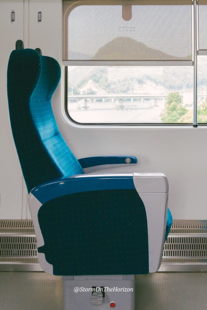 Typical seat on a KoRail train in South Korea. Blue plush seats, lots of leg room and you can eat snacks while travelling.