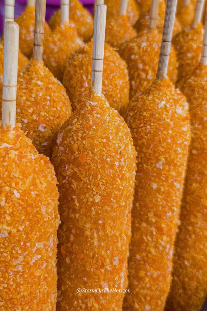 Close up of corn dogs in South Korea. Shared by Storm on the Horizon in a travel guide about vegetarian food in Seoul