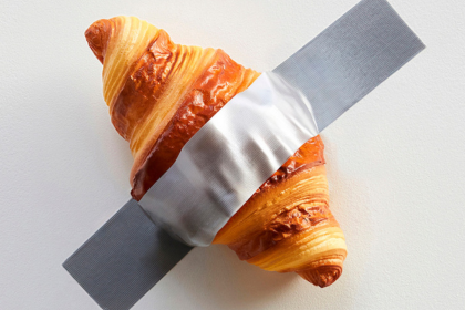 A golden croissant taped to a white wall in Seoul, South Korea. This croissant on a wall can be found in Gangnam - specifically at Nudake Cafe which specialises in croissants. Shared by Storm on the Horizon: A travel site covering solo travel in Europe, the UK and South Korea.